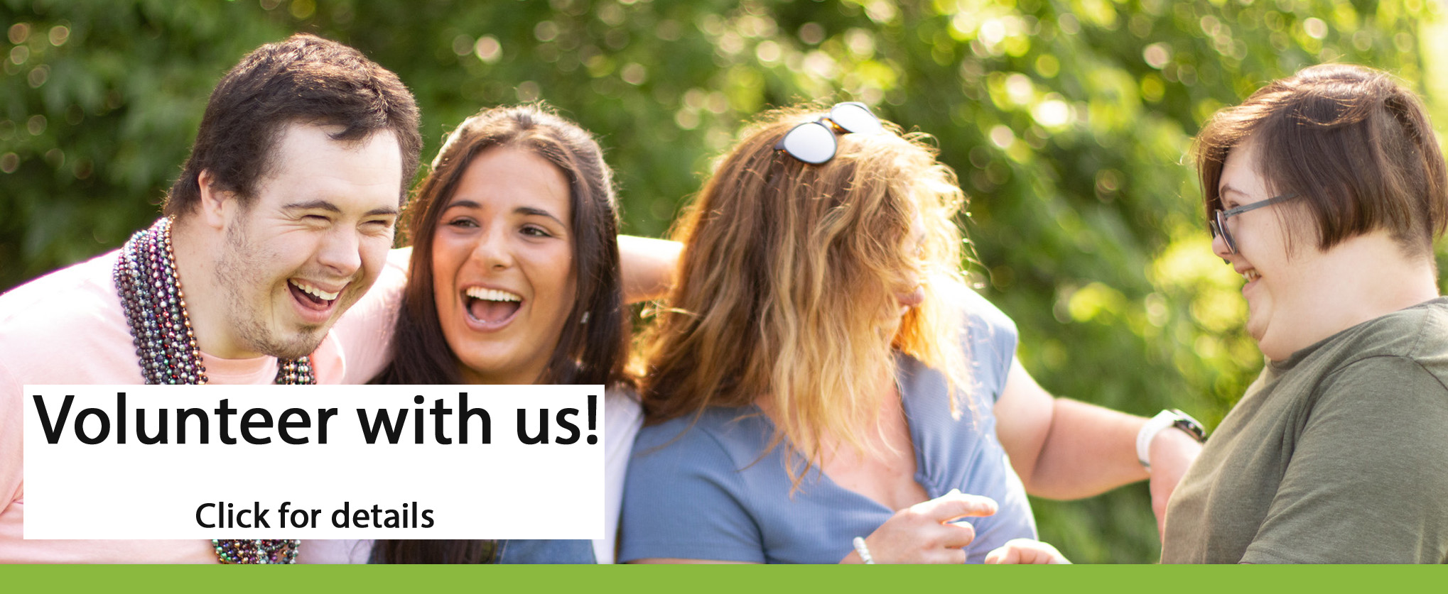 Four-young-people-stand-together-laughing-and-smiling-with-caption-reading-volunteer-with-us-click-for-details